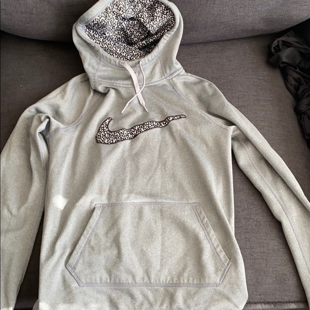 Grey and black nike therma-fit hoodie.